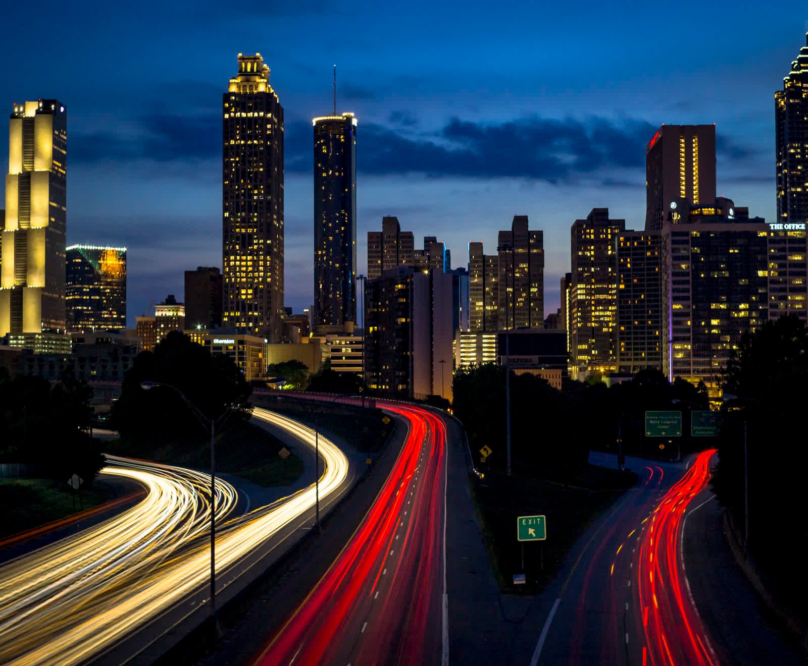 The Atlanta skyline above the Downtown Connector at dusk