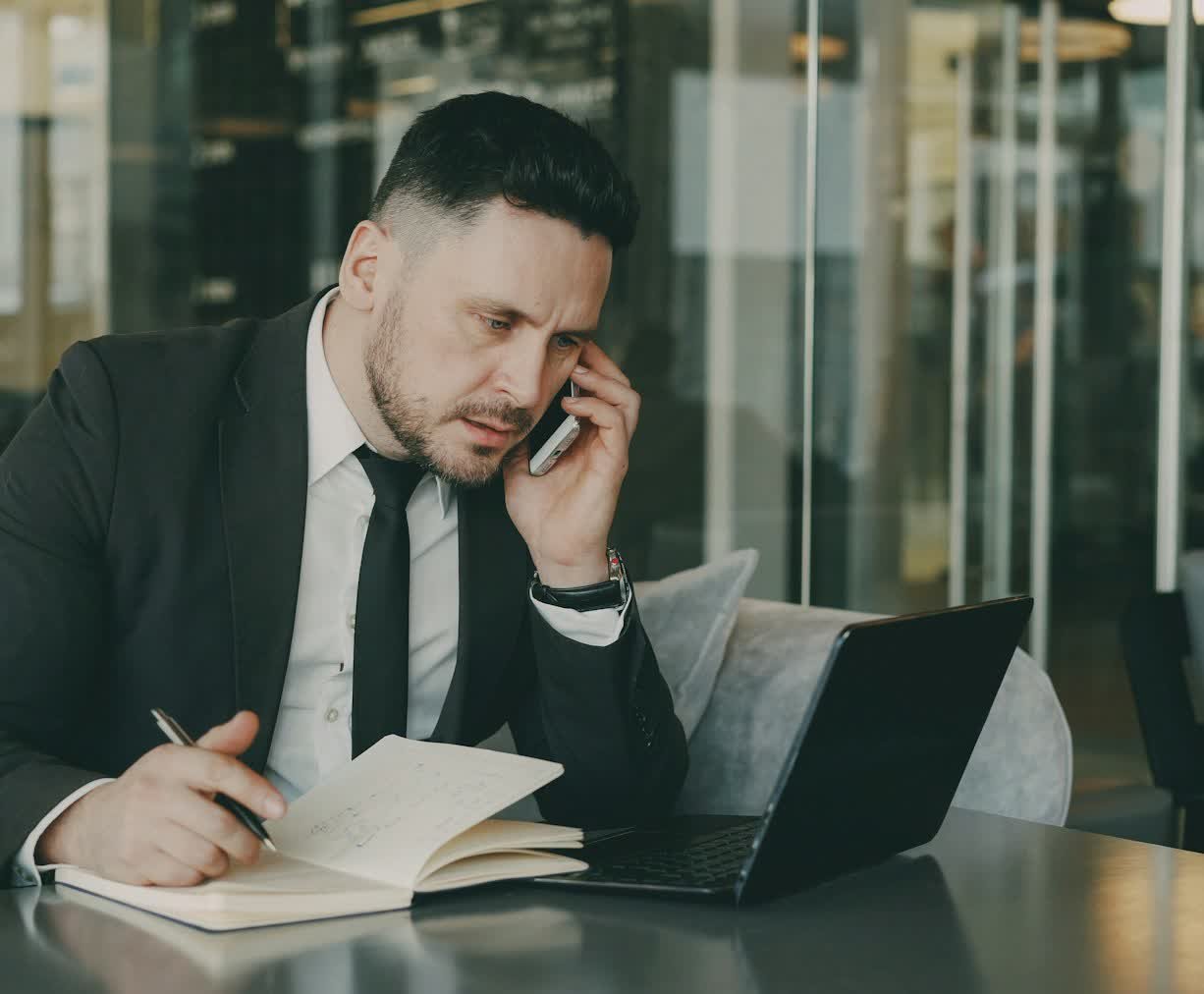 An attorney taking a call and writing down the case details