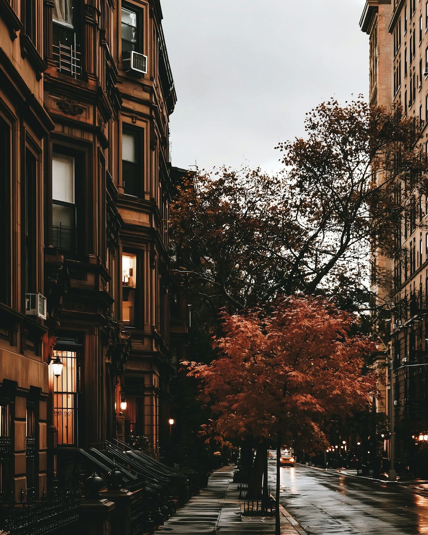 Row houses along a city street in the fall, the kind of neighborhood clients search from